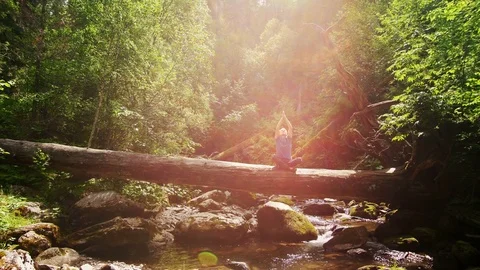 A man is relaxing against the background of a mountain river Stock Footage