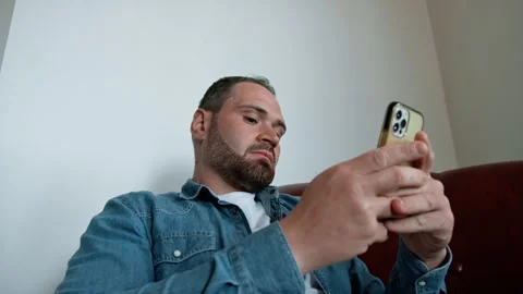Man Relaxing And Chatting On The Sofa Stock Footage 276185474