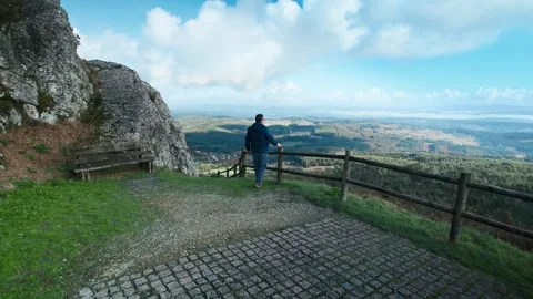 Man relaxing and sitting on a bench on the Sacred Peak in Galicia Stock Footage 336719593