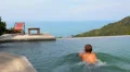 Man Relaxing and Swimming in Endless Luxurious Pool HD Footage