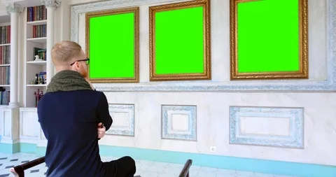 Man relaxing in art gallery while sitting on stool Stock Footage 112535900
