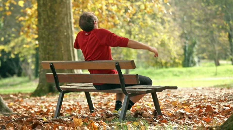 Man relaxing on bench Stock Footage