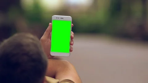Man relaxing on a bench reading on a mobile Stock Footage 112155220