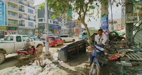 A Man Relaxing With A Busy Traffic Intersection In Sihanoukville, Cambodia Stock Footage 151185704