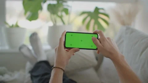 Man relaxing on couch interacting with phone, landscape, mockup 库存影片 218466965