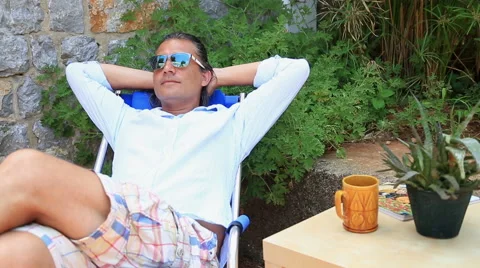 Man relaxing in the garden Stock Footage 53276915