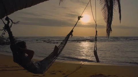Man Relaxing In Hammock On The Beach Stock Footage 95438671
