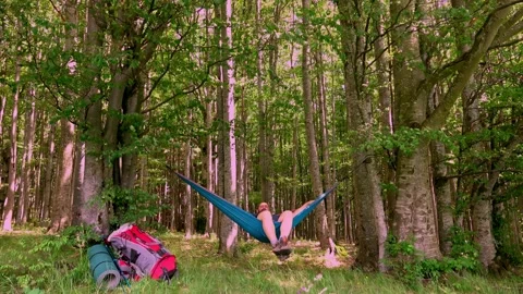 Man relaxing in hammock at sunset in the mountains Stock Footage 133322280