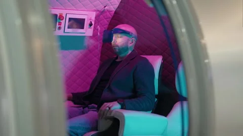 Man relaxing in a hyperbaric oxygen therapy chamber with VR headset Stock Footage 342742650