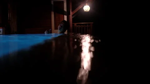 Man Relaxing in an Infinity Pool at Night with Blue Underwater Illumination Stock Footage 340066087