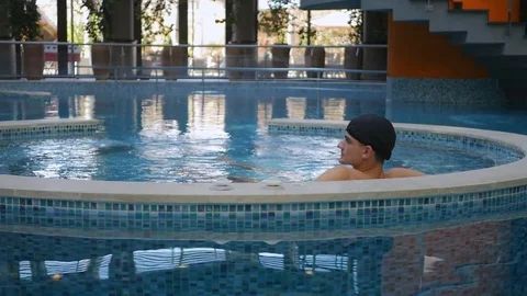 Man relaxing in jacuzzi Stock Footage 83466428