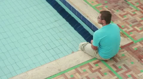 Man relaxing by the pool 스톡 동영상 10842115