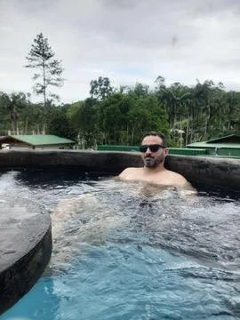 Man relaxing in the pool Stock Photos