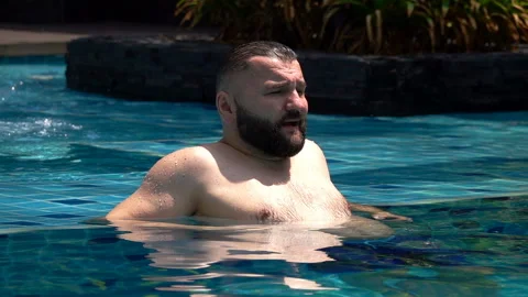 Man relaxing in the pool, slow motion shot at 240fps Stock Footage 88538260