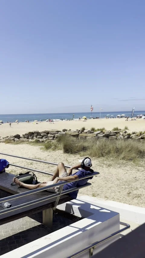 Man relaxing at Ribeira D Ilhas beach Ericeira Stock Footage 304883156