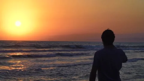 Man relaxing at sea, looking at sunset and enjoying nature Stock Footage 133374449