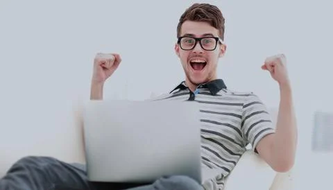 Man Relaxing on Sofa with Laptop Computer Stock Photos