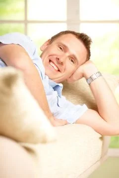 Man relaxing on sofa Stock Photos