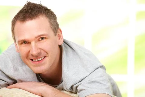 Man relaxing on sofa Stock Photos