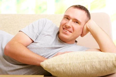 Man relaxing on sofa Stock Photos