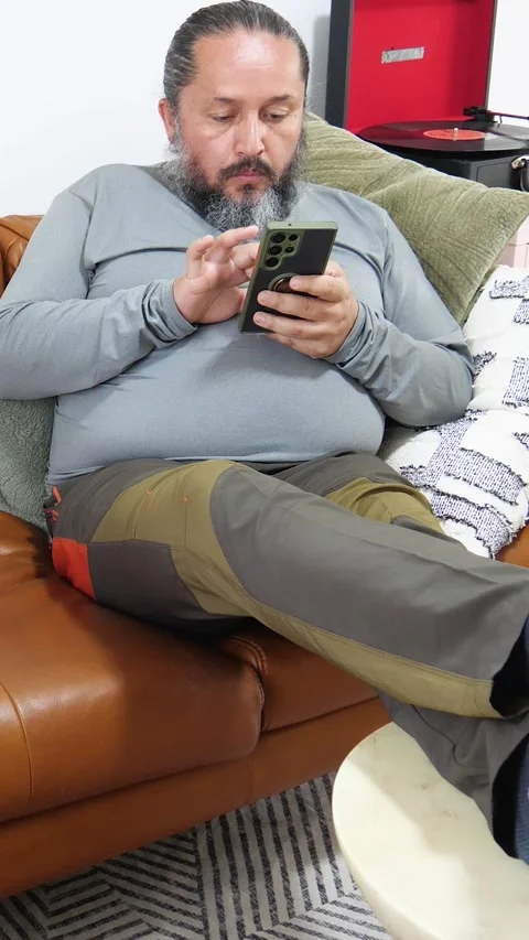 Man Relaxing On Sofa While Using Smartphone Video stock 347326640
