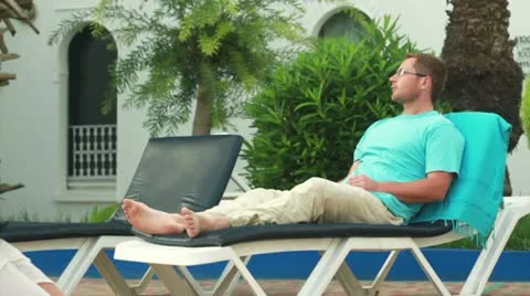 Man relaxing on sunbed Stock Footage 10848830