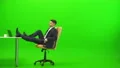 The man relaxing at the table on the green background 4k or 4k+ Resolution