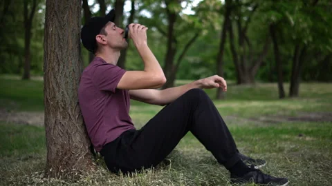 Man Relaxing Under Tree, Coffee Break in Nature Stock Footage 276680931