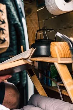 Man relaxing while reading in a converted van 스톡 사진