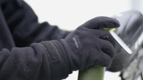 Man reloading paintball marker gun close up slow motion. Stock Footage 125272562