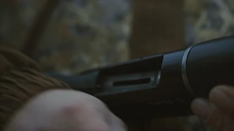 A man reloading a shotgun closeup Stock Footage 237931532