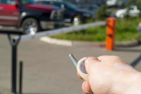 Man with remote control automatic barrier opens Stock Photos