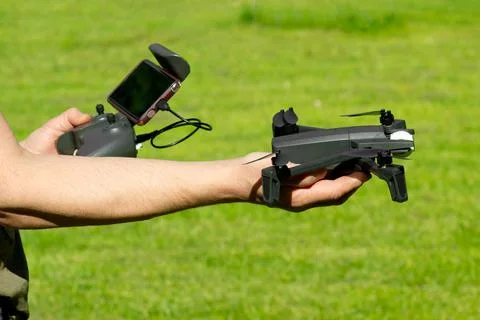 Man with remote control cell phone hold drone.  Stock Photos