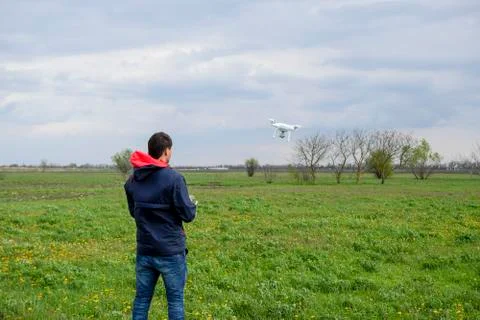 A man with a remote control in his hands. Flight control of the drone. Phanto Stock Photos