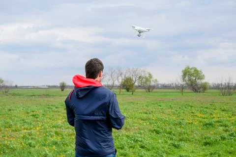 A man with a remote control in his hands. Flight control of the drone. Phanto Stock Photos