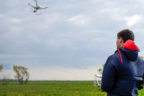 A man with a remote control in his hands. Flight control of the drone. Phanto Stock Photos