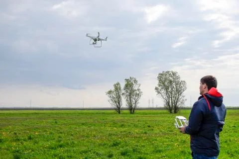 A man with a remote control in his hands. Flight control of the drone. Phanto Stock Photos