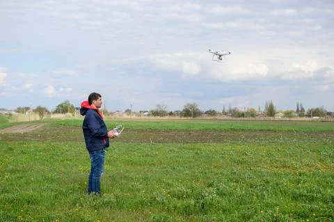 A man with a remote control in his hands. Flight control of the drone. Phanto Stock Photos