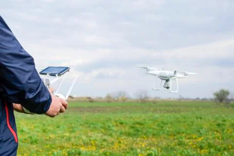 A man with a remote control in his hands. Flight control of the drone. Phanto Stock Photos