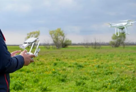 A man with a remote control in his hands. Flight control of the drone. Phanto Stock Photos