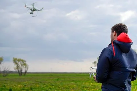 A man with a remote control in his hands. Flight control of the drone. Phanto Stock Photos