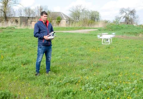 A man with a remote control in his hands. Flight control of the drone. Phanto Stock Photos