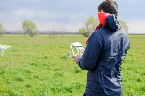 A man with a remote control in his hands. Flight control of the drone. Phanto Stock Photos