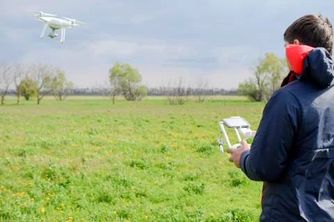 A man with a remote control in his hands. Flight control of the drone. Phanto Stock Photos