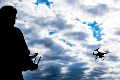 A man with a remote control in his hands. Controlling the flight Stock Photos