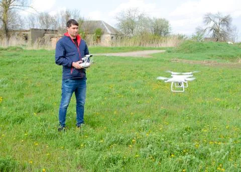 A man with a remote control in his hands. Flight control of the drone. Phantom Stock Photos