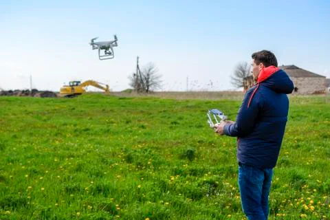 A man with a remote control in his hands. Flight control of the drone. Phantom Stock Photos