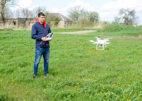 A man with a remote control in his hands. Flight control of the drone. Phantom Stock Photos