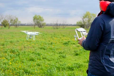 A man with a remote control in his hands. Flight control of the drone. Phantom Stock Photos
