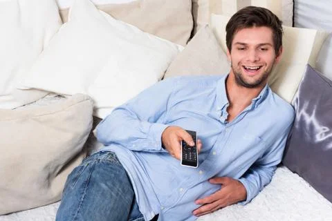 Man with remote control Stock Photos